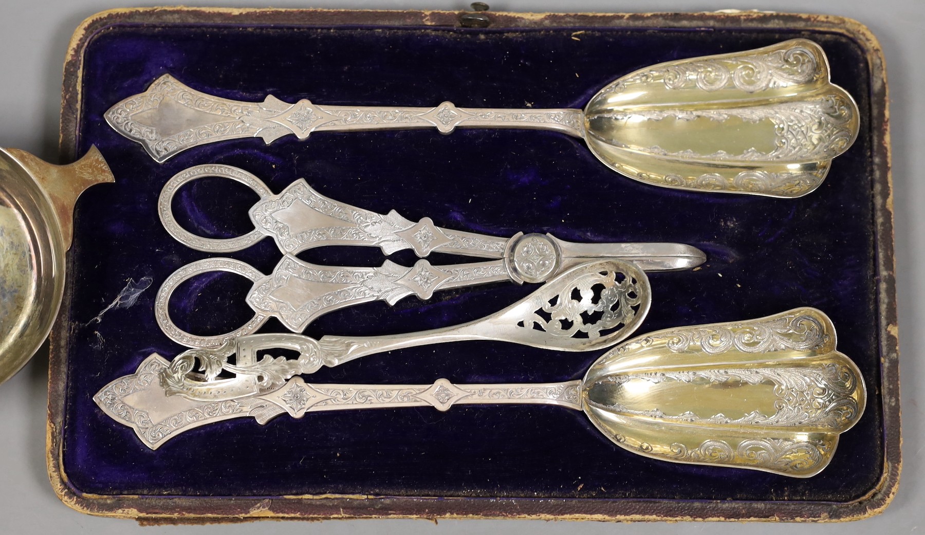 An Elizabeth II silver quaich, Glasgow, 1964, 13cm over handles, a cased plated three piece dessert set and a Dutch white metal spoon.